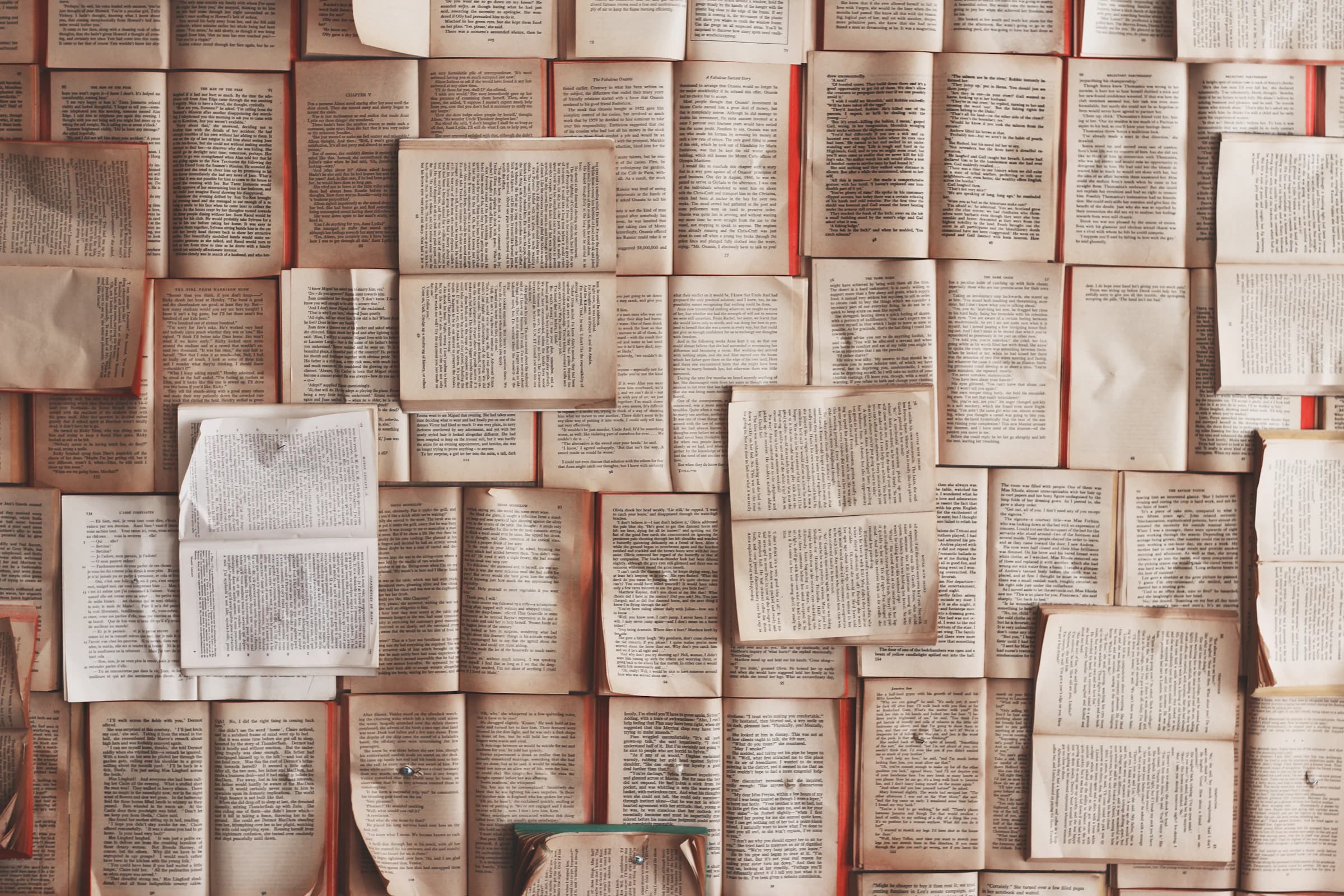 Open books arranged in a wall of overlapping pages